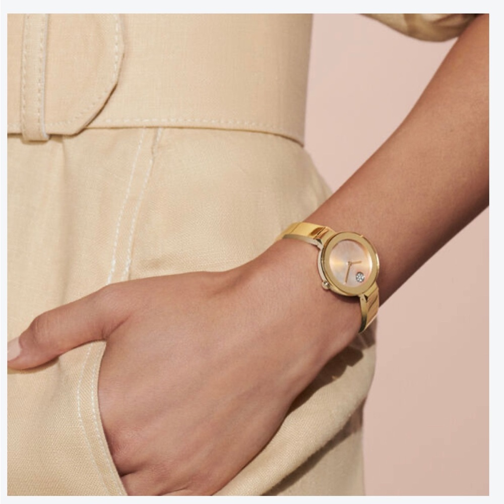 Movado luxury women’s watch with mother of pearl face and silver cuff wristband